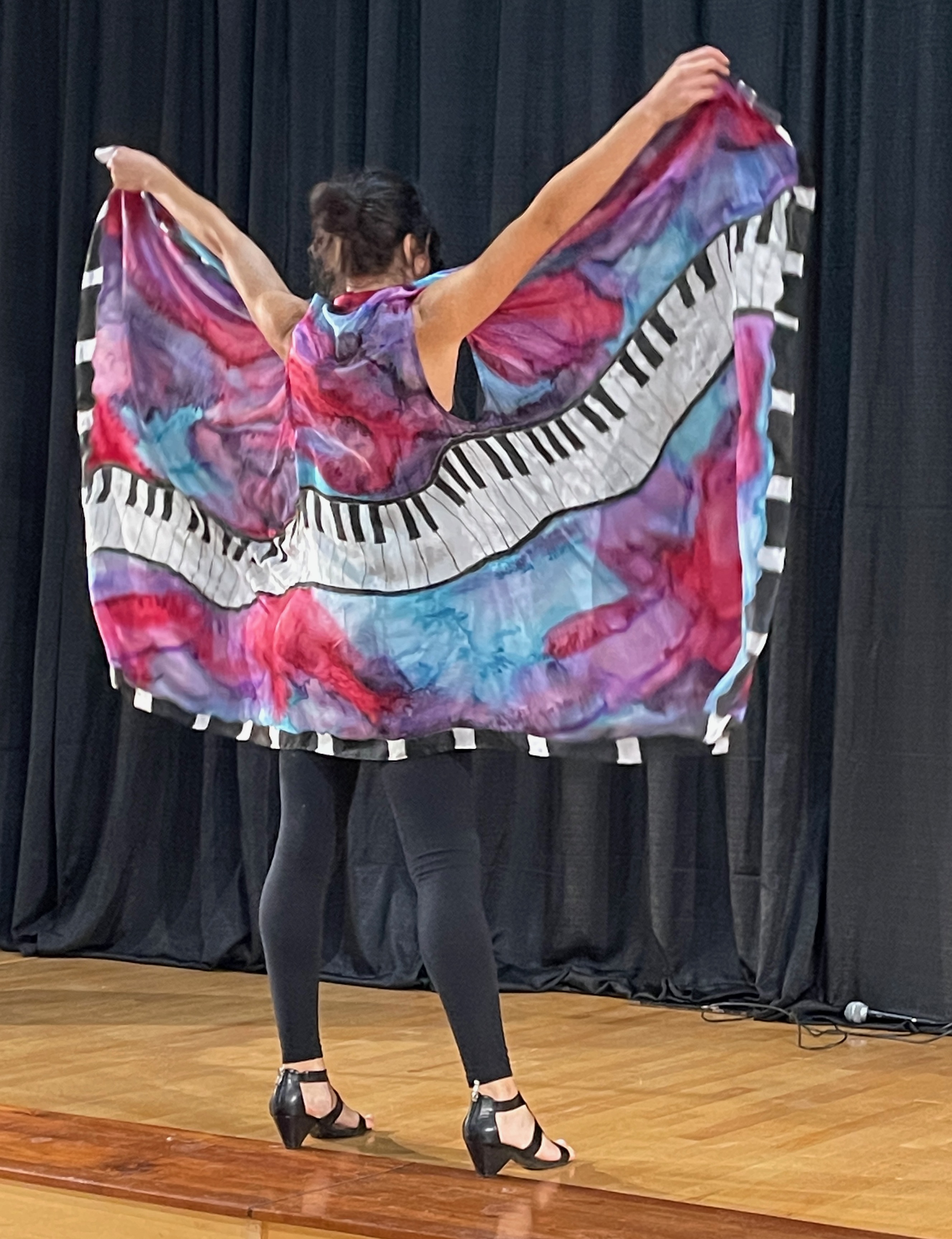 Festival fashion show moment featuring keyboard cape design